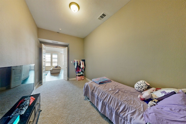 carpeted bedroom with lofted ceiling