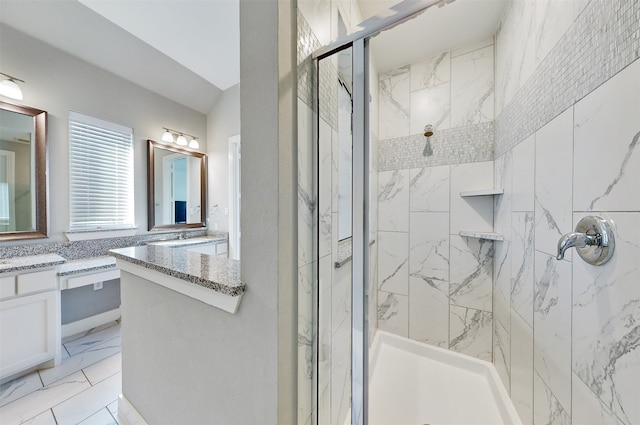 bathroom featuring vanity and a shower with shower door