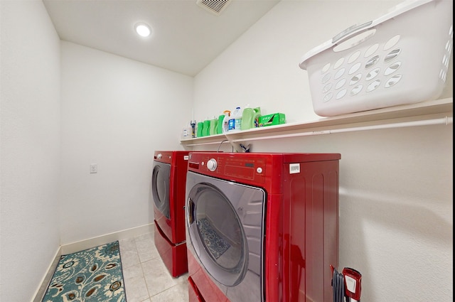 washroom featuring washer and clothes dryer and light tile patterned flooring