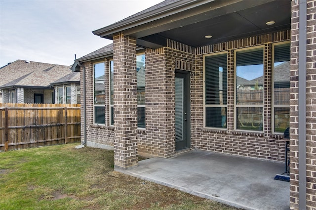 view of exterior entry featuring a patio area