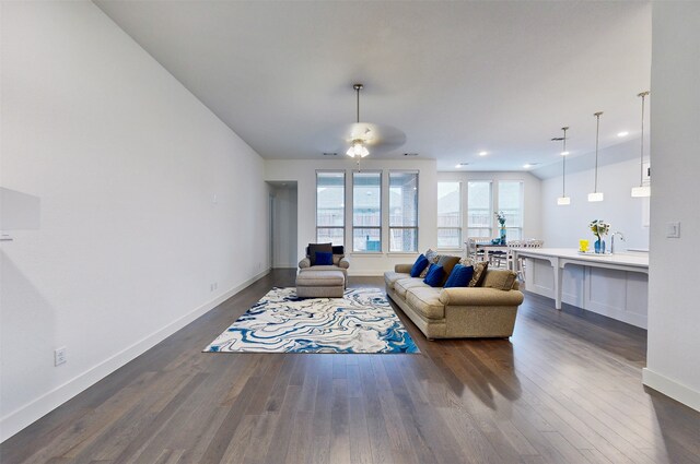 living room featuring ceiling fan and hardwood / wood-style flooring