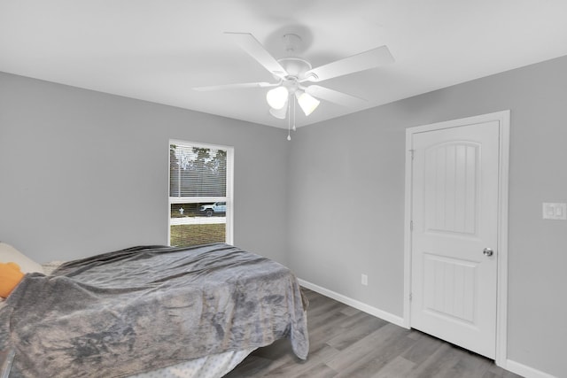 bedroom with wood-type flooring and ceiling fan