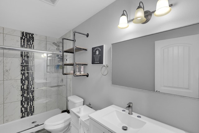 bathroom with vanity, toilet, and an enclosed shower