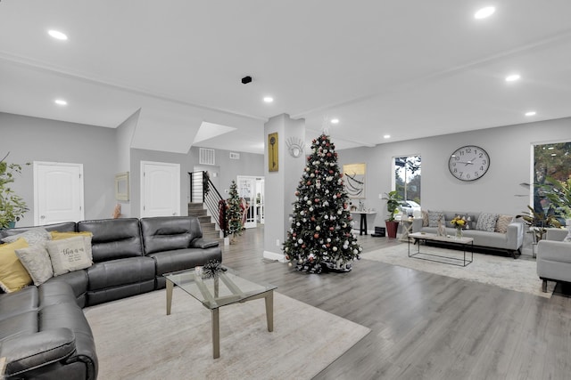 living room with a healthy amount of sunlight and light hardwood / wood-style floors