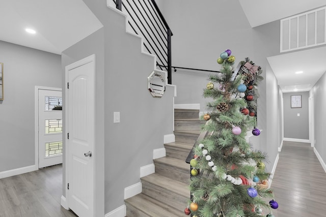 staircase with hardwood / wood-style flooring