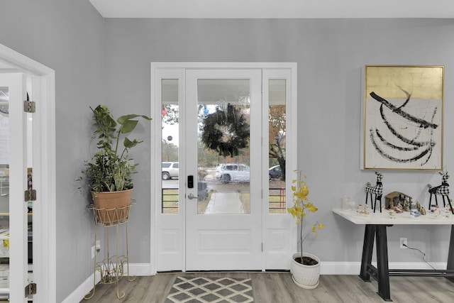 foyer entrance with light hardwood / wood-style floors and a wealth of natural light