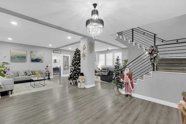 living room with a chandelier and light hardwood / wood-style floors