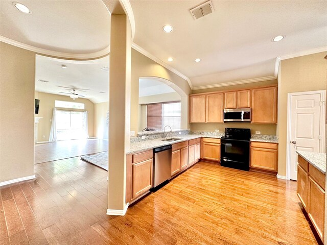 kitchen featuring light stone counters, light hardwood / wood-style flooring, ceiling fan, and appliances with stainless steel finishes