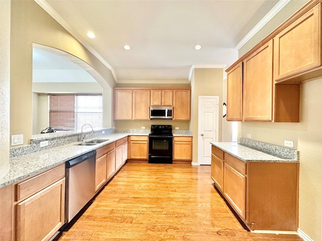 kitchen featuring sink, light stone countertops, light wood-type flooring, ornamental molding, and stainless steel appliances