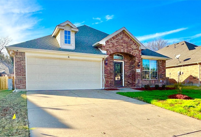 view of front of property featuring a garage and a front lawn