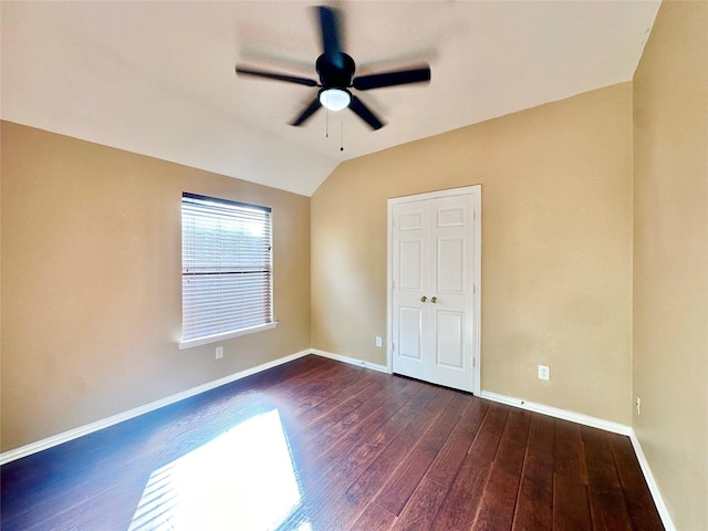 unfurnished bedroom featuring ceiling fan, dark hardwood / wood-style flooring, and lofted ceiling