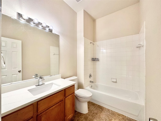 full bathroom with vanity, tiled shower / bath combo, toilet, and tile patterned flooring