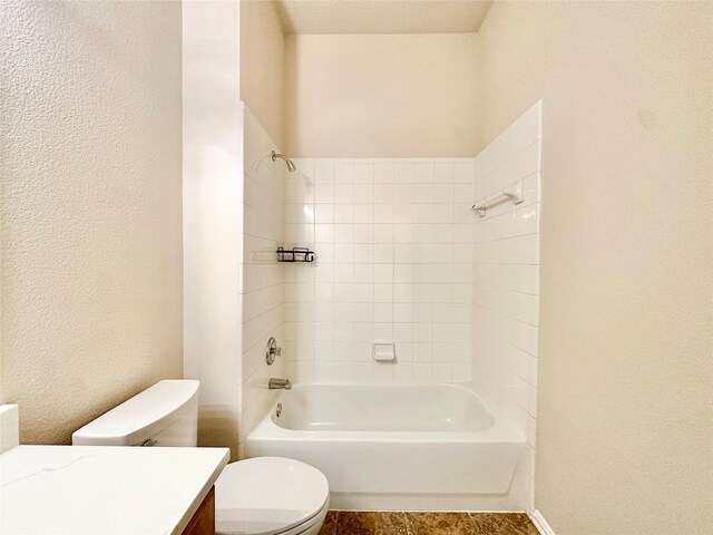 full bathroom with toilet, vanity, and tiled shower / bath combo