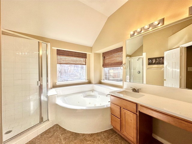 bathroom featuring tile patterned flooring, vanity, separate shower and tub, and vaulted ceiling