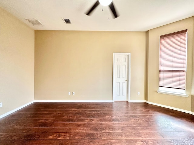 empty room featuring dark hardwood / wood-style floors and ceiling fan