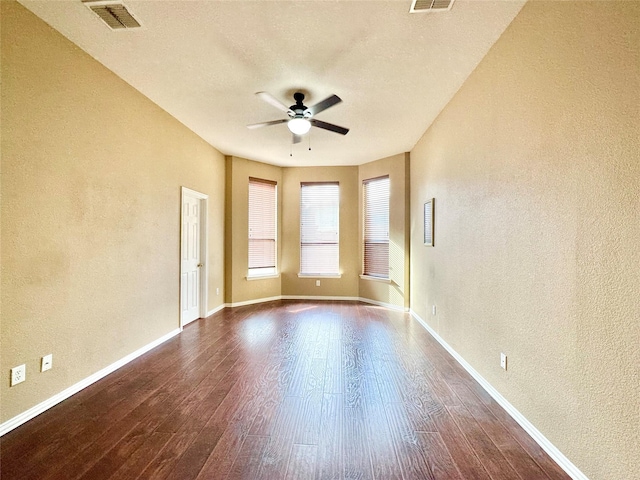 spare room with ceiling fan and wood-type flooring