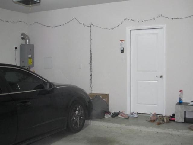 garage with water heater and a garage door opener