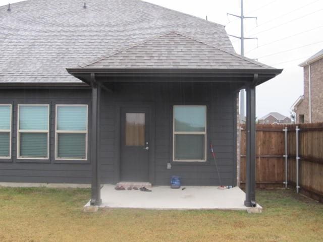 back of house featuring a yard and a patio