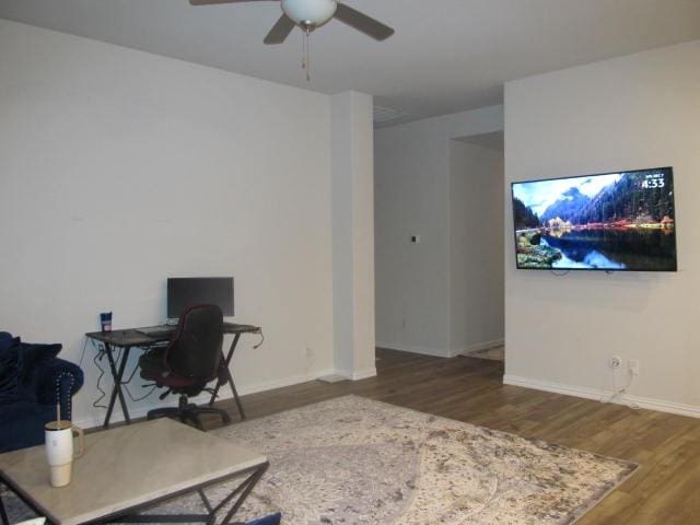 home office featuring dark hardwood / wood-style flooring and ceiling fan