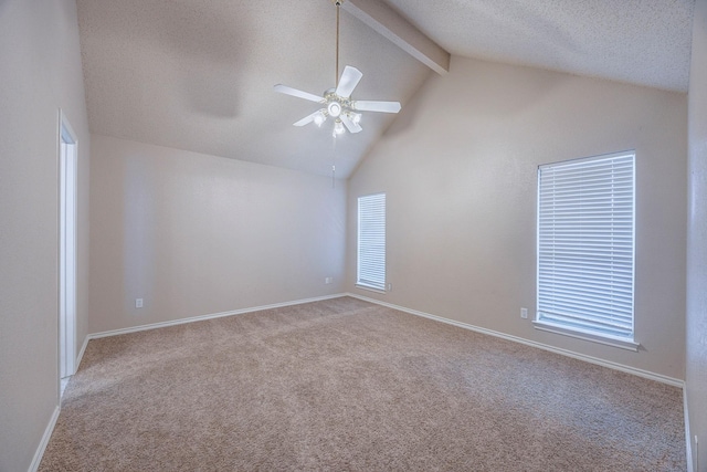 carpeted spare room featuring a textured ceiling, vaulted ceiling with beams, and ceiling fan