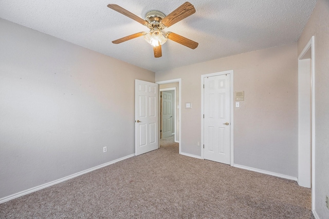 unfurnished bedroom with carpet flooring, a textured ceiling, and ceiling fan