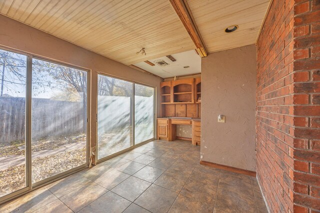 unfurnished sunroom featuring wood ceiling