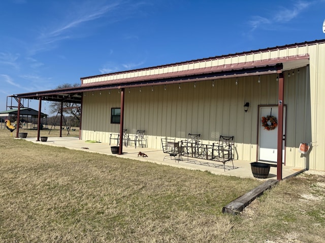 back of property featuring a yard and a patio