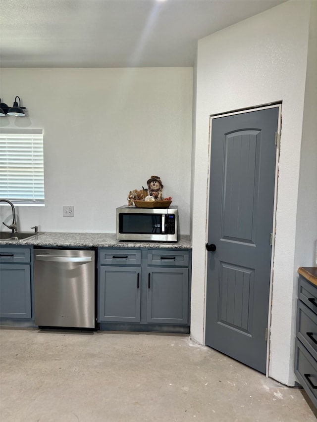 kitchen featuring gray cabinets, sink, and appliances with stainless steel finishes