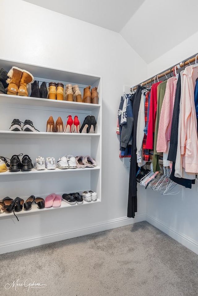 spacious closet with carpet and vaulted ceiling