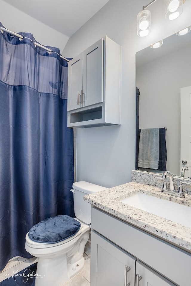 bathroom featuring tile patterned flooring, vanity, and toilet