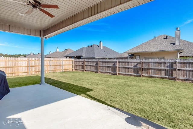 view of yard with ceiling fan and a patio