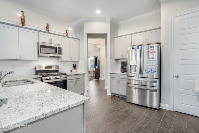 kitchen featuring dark wood-type flooring, sink, gray cabinets, light stone countertops, and appliances with stainless steel finishes