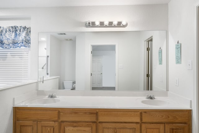 bathroom with vanity and toilet