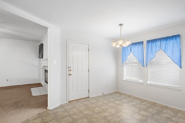 spare room with a chandelier and ornamental molding