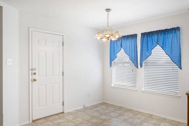 unfurnished room featuring a notable chandelier