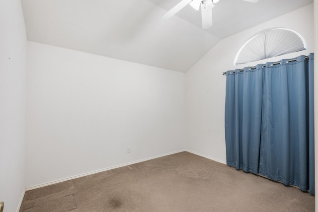 carpeted empty room featuring ceiling fan and lofted ceiling