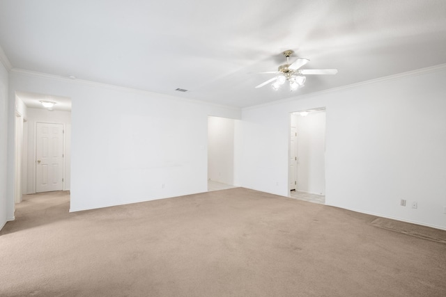 carpeted empty room with ceiling fan and crown molding