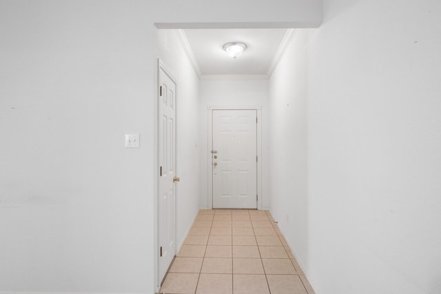 hallway featuring ornamental molding and light tile patterned floors