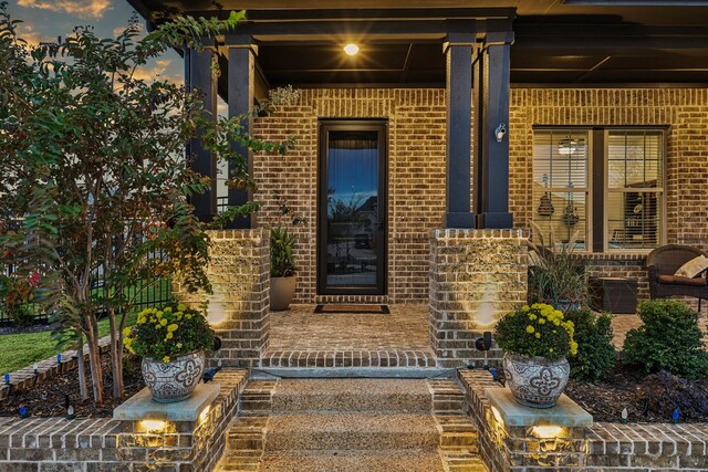 patio terrace at dusk with an outdoor living space with a fire pit