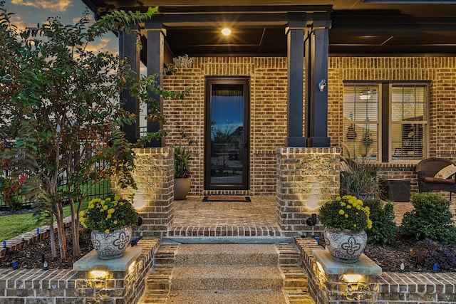 exterior entry at dusk with covered porch