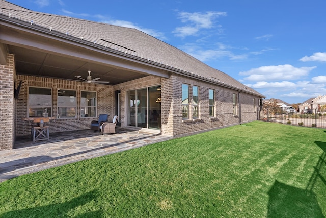 rear view of property featuring a patio, ceiling fan, and a lawn