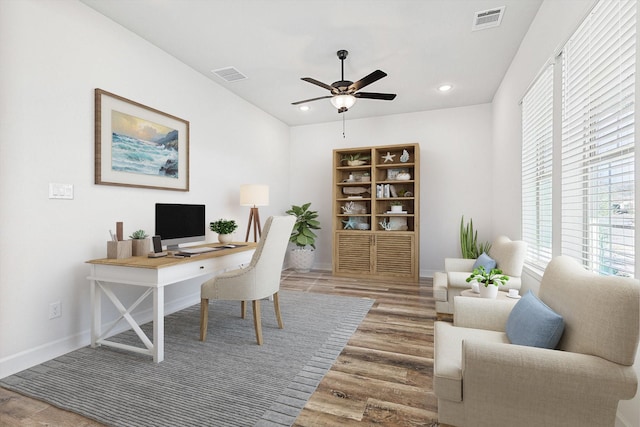 office with hardwood / wood-style flooring and ceiling fan