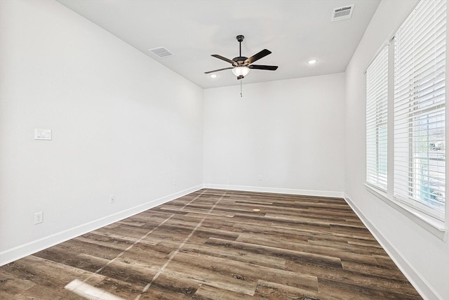 empty room with dark wood-type flooring and ceiling fan