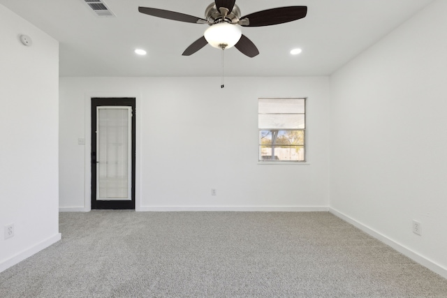 carpeted empty room with recessed lighting, visible vents, and baseboards