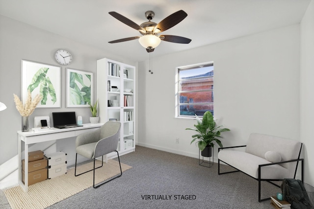 carpeted office featuring ceiling fan and baseboards