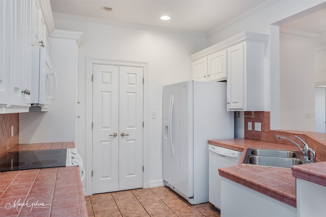 kitchen featuring ornamental molding, white appliances, sink, tile countertops, and white cabinets