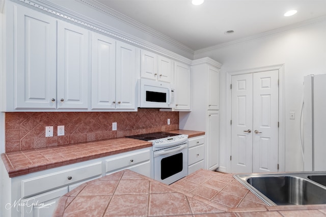 kitchen with backsplash, white appliances, tile countertops, and white cabinets