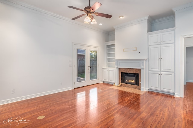 unfurnished living room featuring ceiling fan, french doors, crown molding, and light hardwood / wood-style flooring