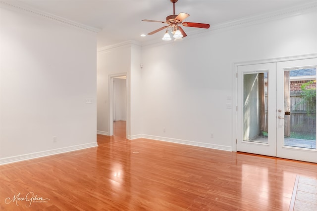 spare room with light hardwood / wood-style flooring, ornamental molding, french doors, and ceiling fan