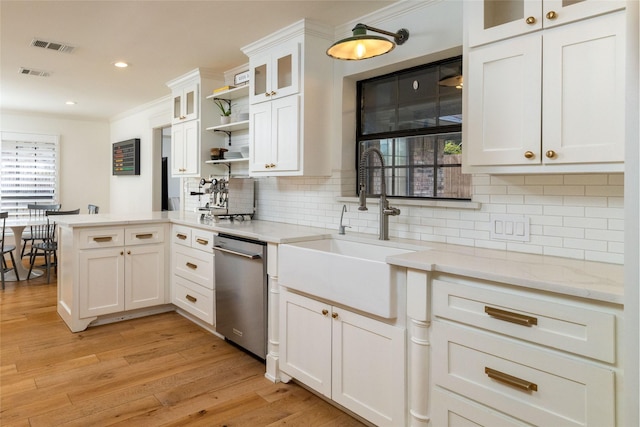 kitchen with sink, white cabinetry, a wealth of natural light, and stainless steel dishwasher